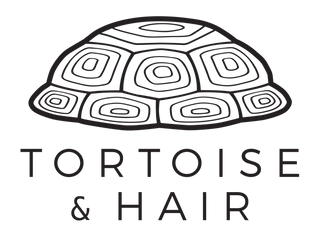 Tortoise and Hair black and white logo: tortoise shell and name of company